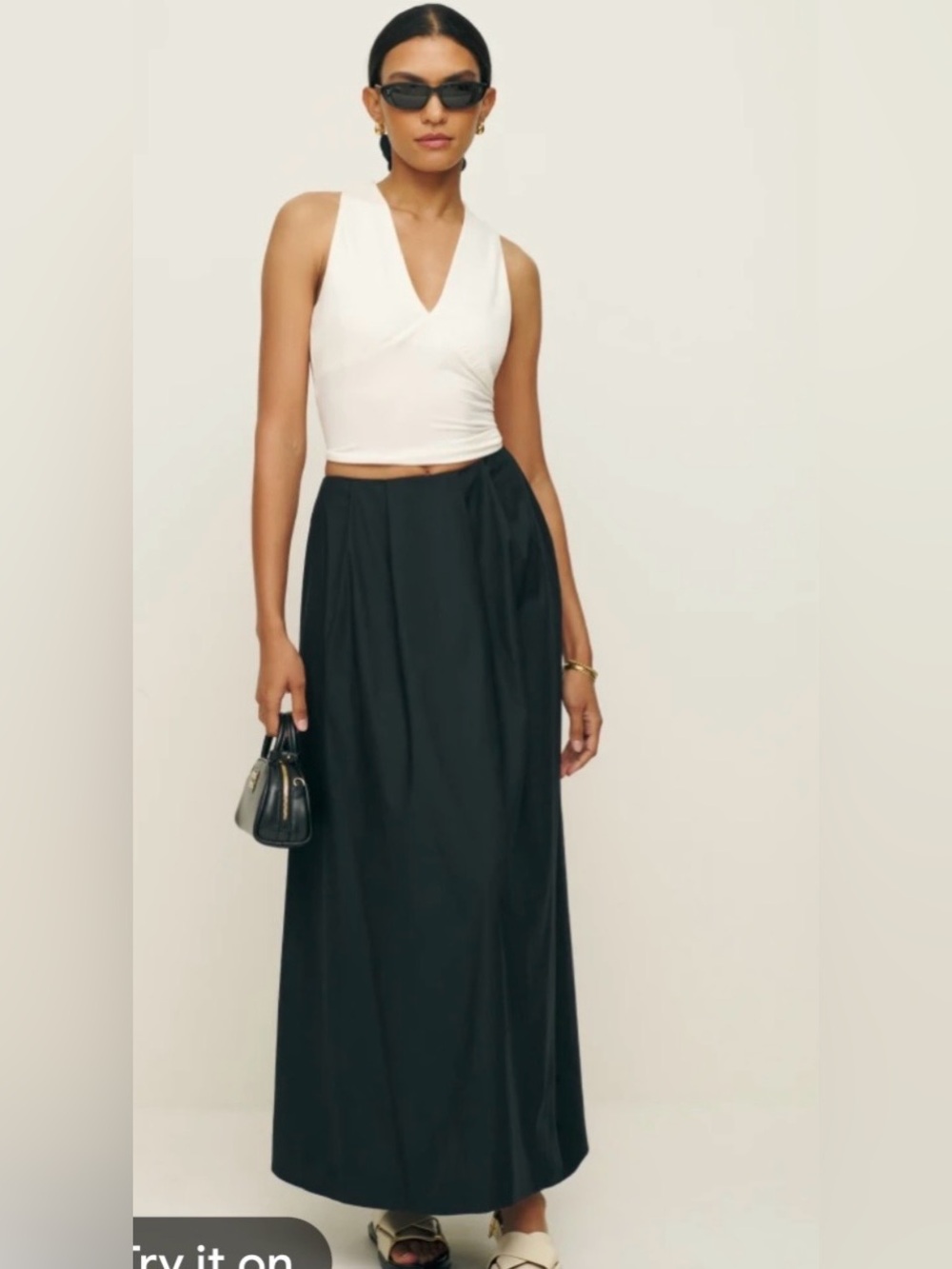 Reformation Lucy Black Maxi Skirt with Flowing Silhouette and pockets.